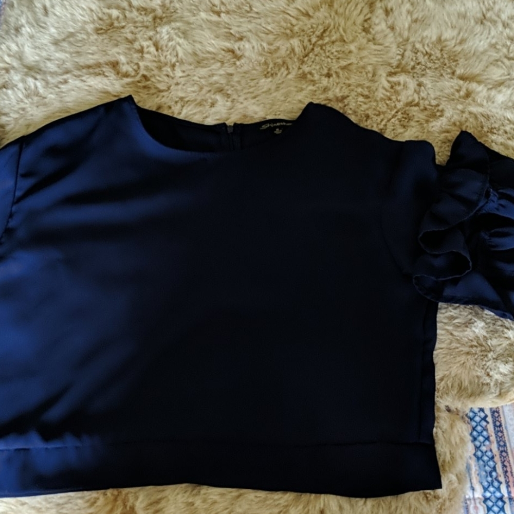 A navy blue ruffle sleave top